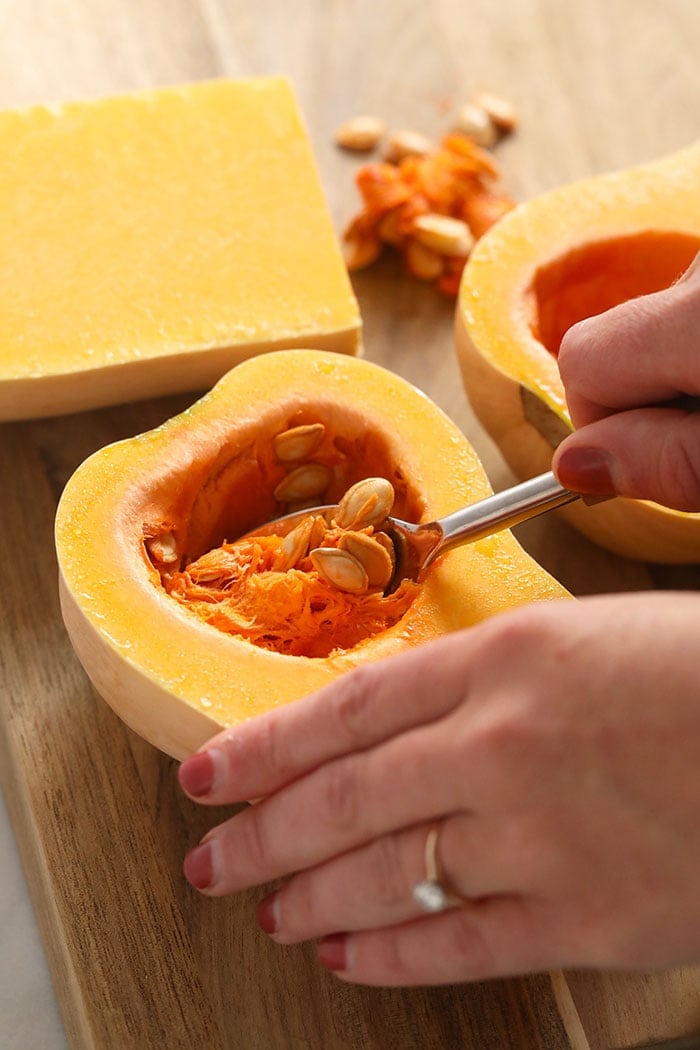 Scooping the innards out of butternut squash