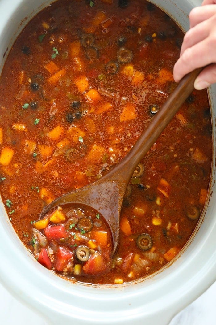 slow cooker taco soup being stirred with a spoon