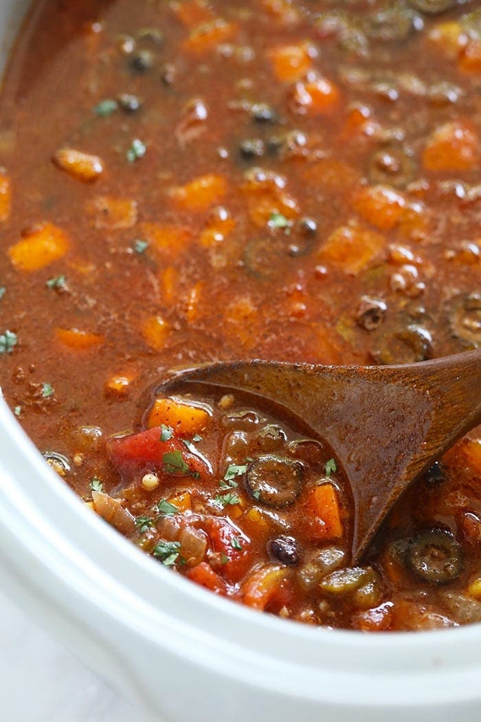 slow cooker taco soup being stirred with a spoon