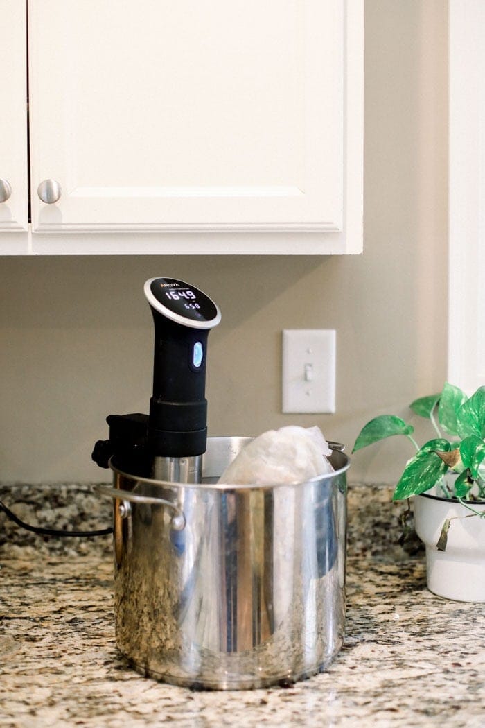 A turkey in a pot of water with a sous vide in the pot. 