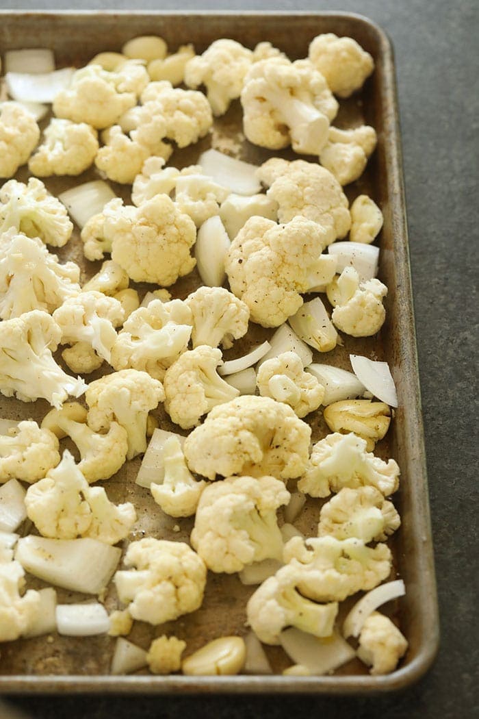 Cauliflower, onion, and garlic on a pan