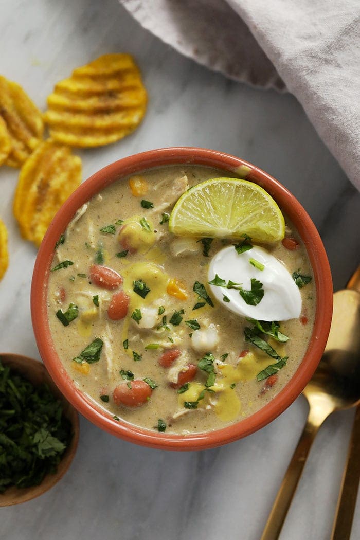 white bean chicken chili in a bowl topped with greek yogurt.