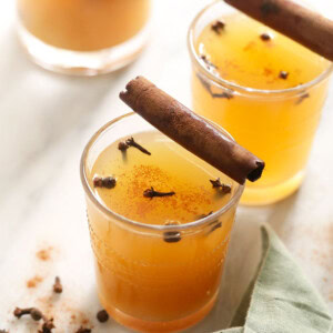 Homemade apple cider infused with cinnamon sticks.