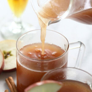 spiked apple cider being poured in a mug