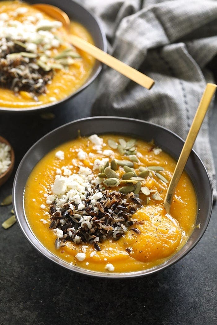 instant pot butternut squash soup in a bowl topped with wild rice and goat cheese