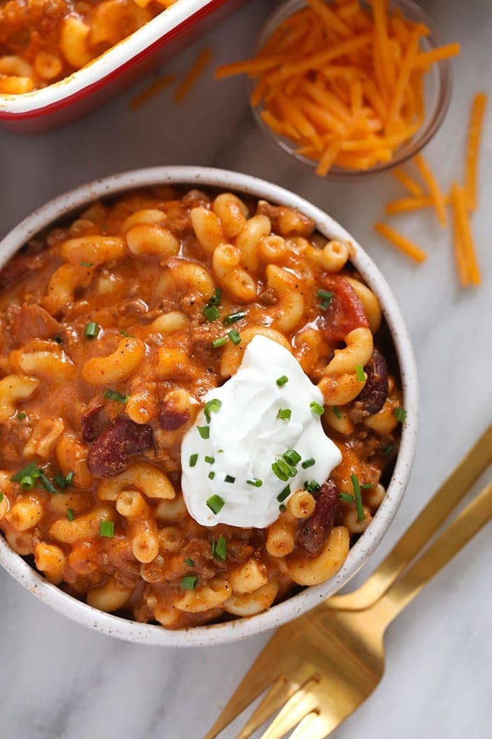 Chili mac in a bowl with greek yogurt scooped on top