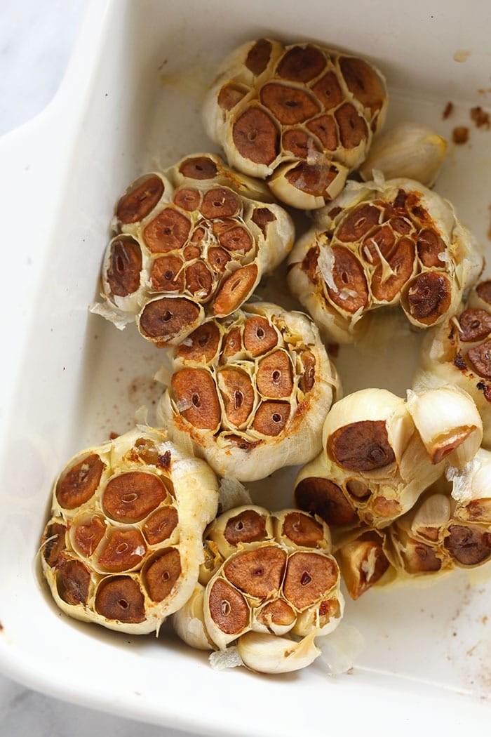 roasted garlic bulbs in a baking dish