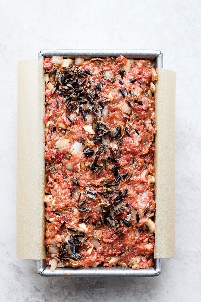 wild rice meatloaf in a loaf pan ready to be baked