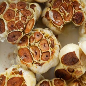 roasted garlic cloves in a baking dish