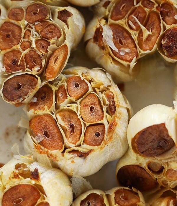 roasted garlic cloves in a baking dish