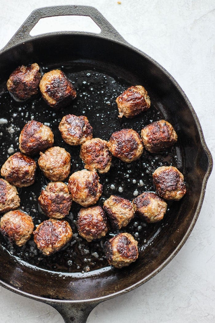 Italian meatballs in cast iron skillet.