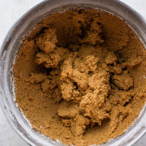 A metal bowl of brown sugar, perfect for making gingersnap cookies.