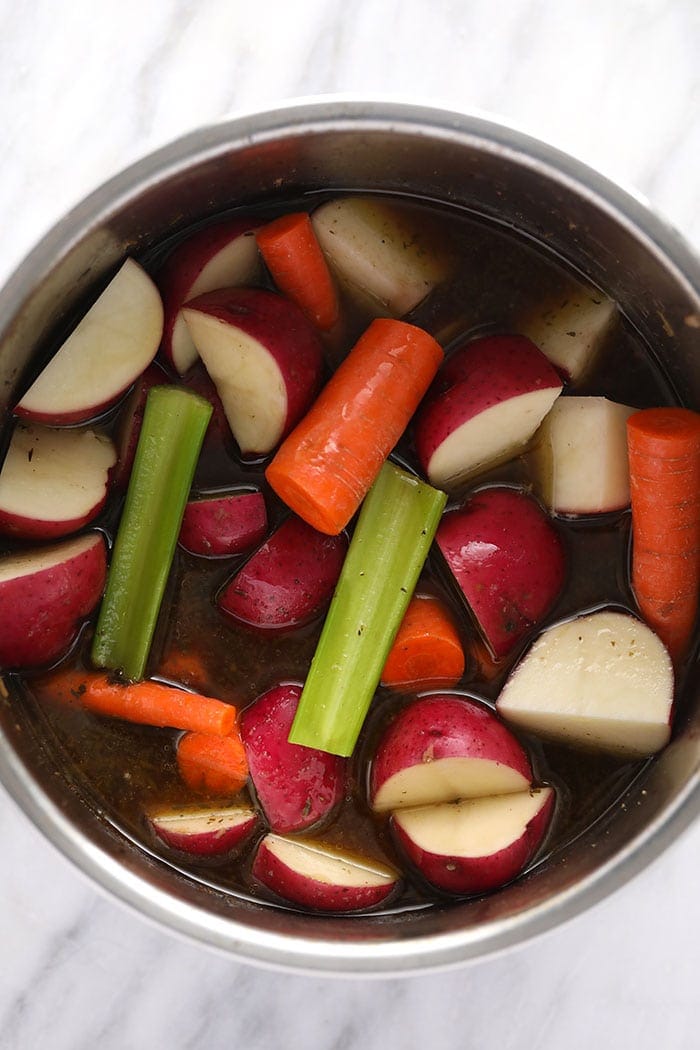 pot roast veggies in the instant pot ready to be pressure cooked