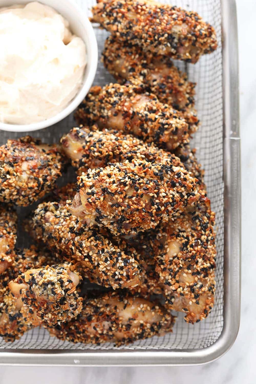 Everything Bagel Seasoning Wings in a basket with dip 