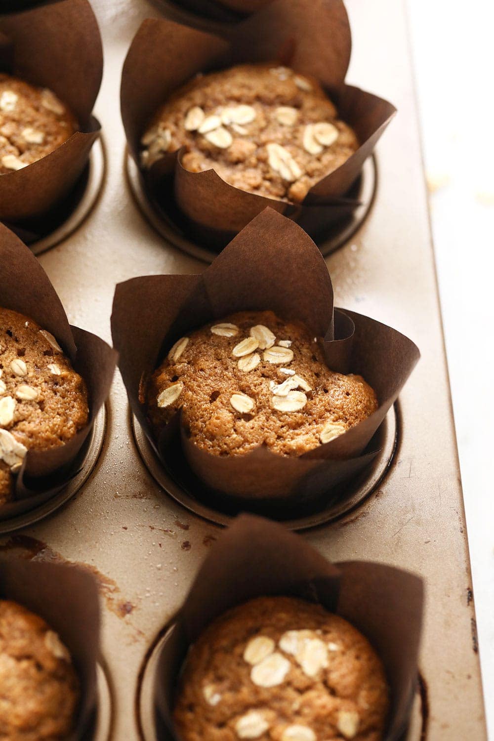 classic oatmeal muffins in a muffin pan after baking