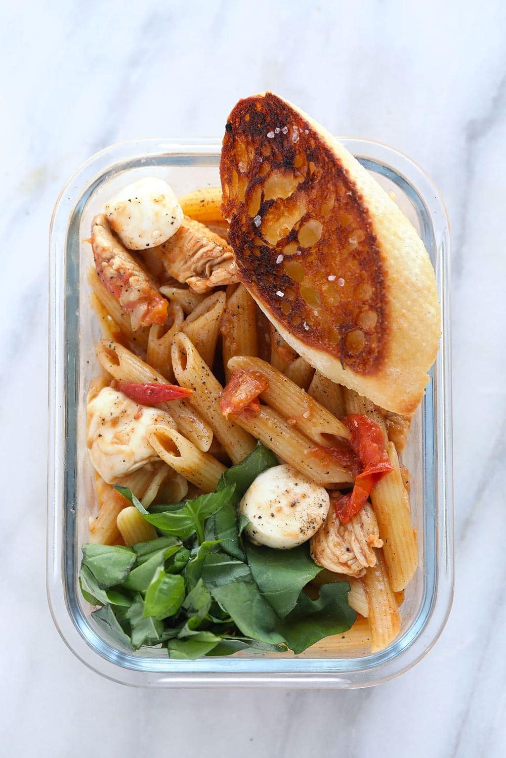 Caprese Chicken Pasta in a meal prep container