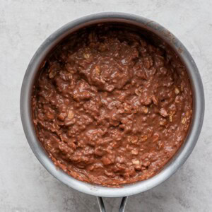 Chocolate batter in a pan on a white surface, made with protein oatmeal.