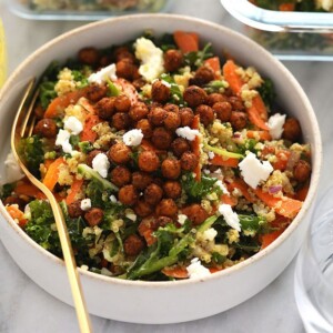 a bowl of quinoa salad with kale and carrots.