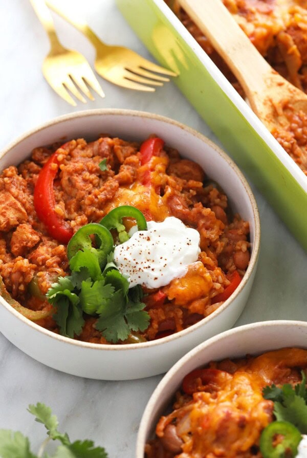 chicken burrito bowl casserole in a bowl topped with a dollop of sour cream