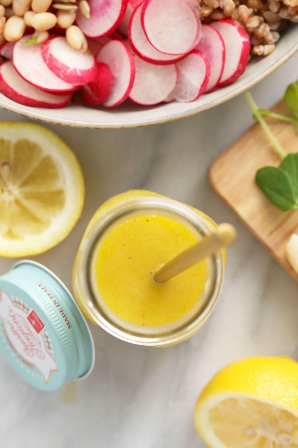 homemade lemon vinaigrette dressing in a jar ready to dress a salad