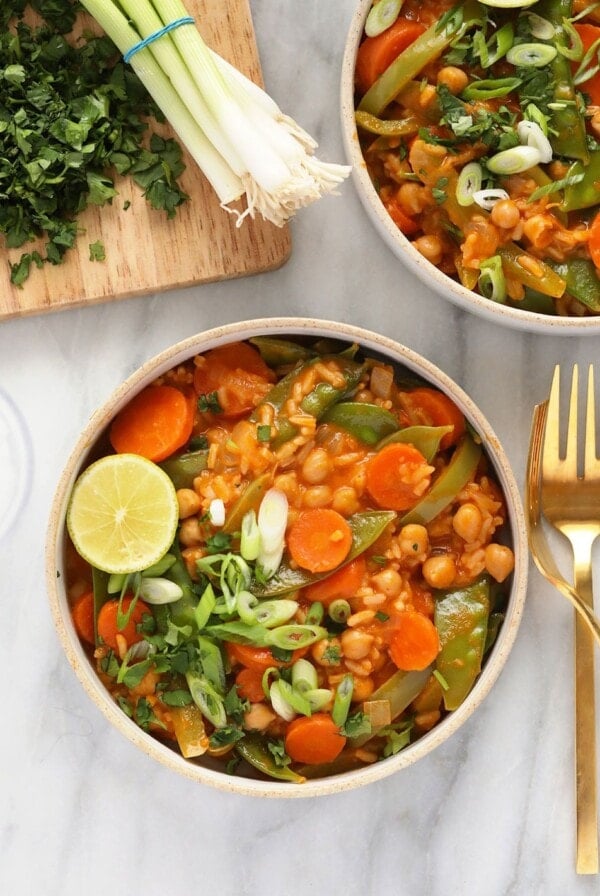 Two bowls of Thai chickpea curry on a marble table.