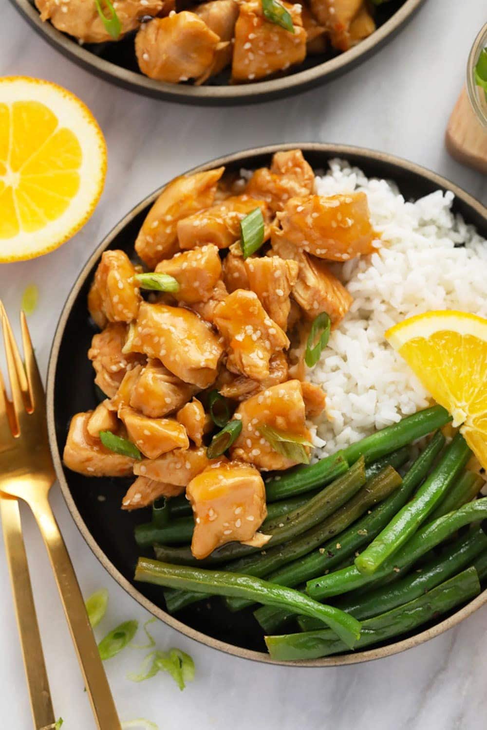 Orange chicken, white rice, and green beans on a plate