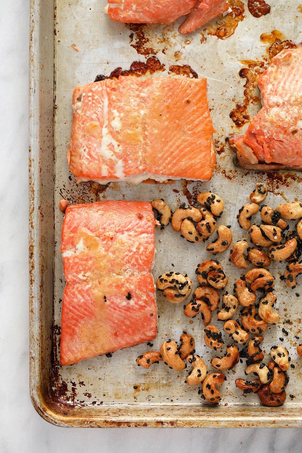 salmon and cashews on pan