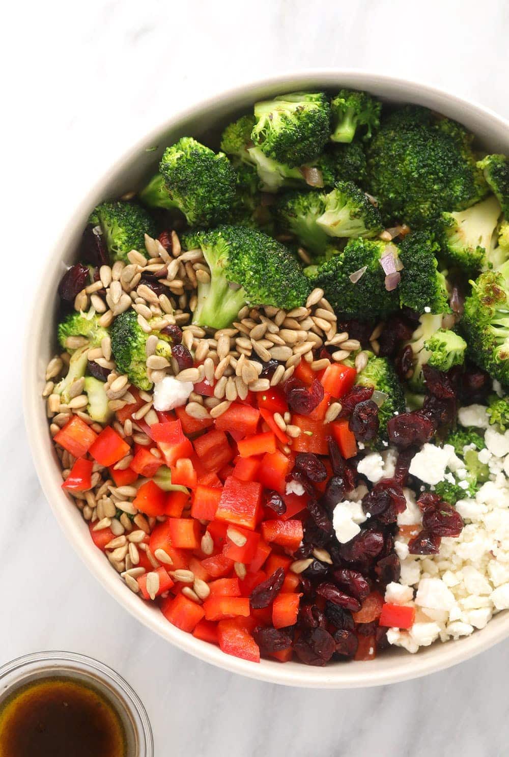 broccoli salad ingredients all together in a bowl ready to be mixed together