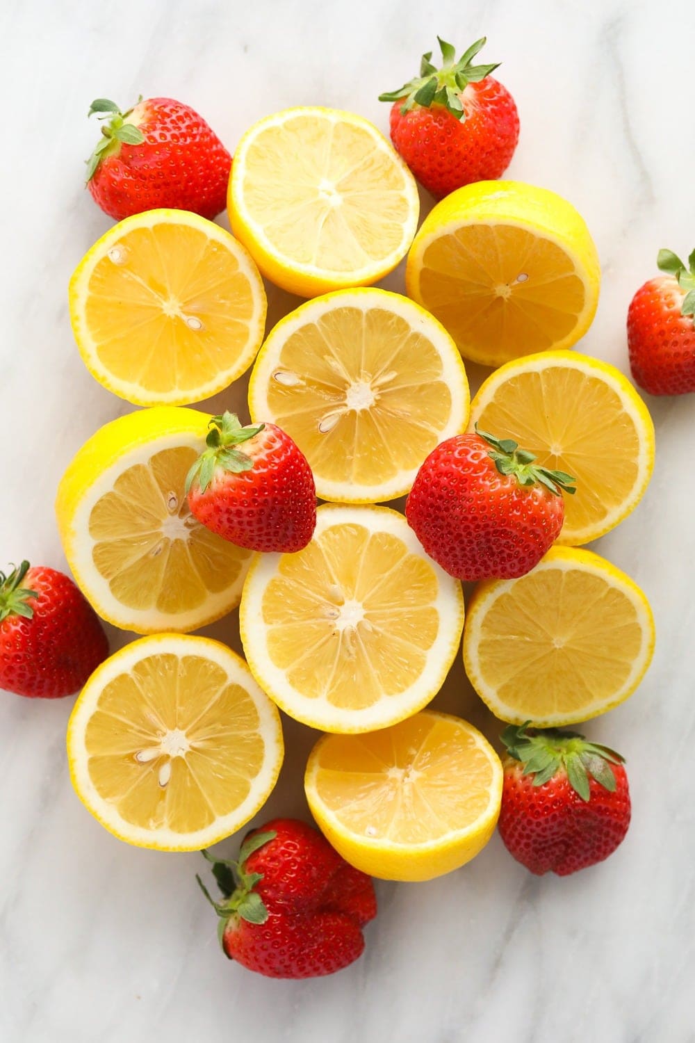 fresh lemons and strawberries ready to be made into strawberry vodka lemonade