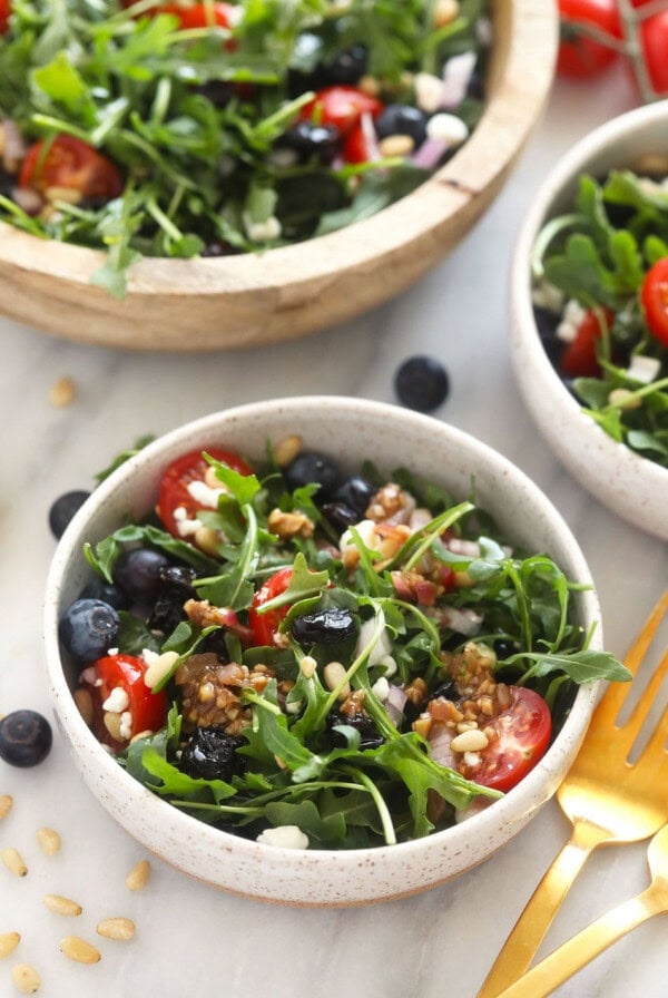 Arugula salad in a small bowl.