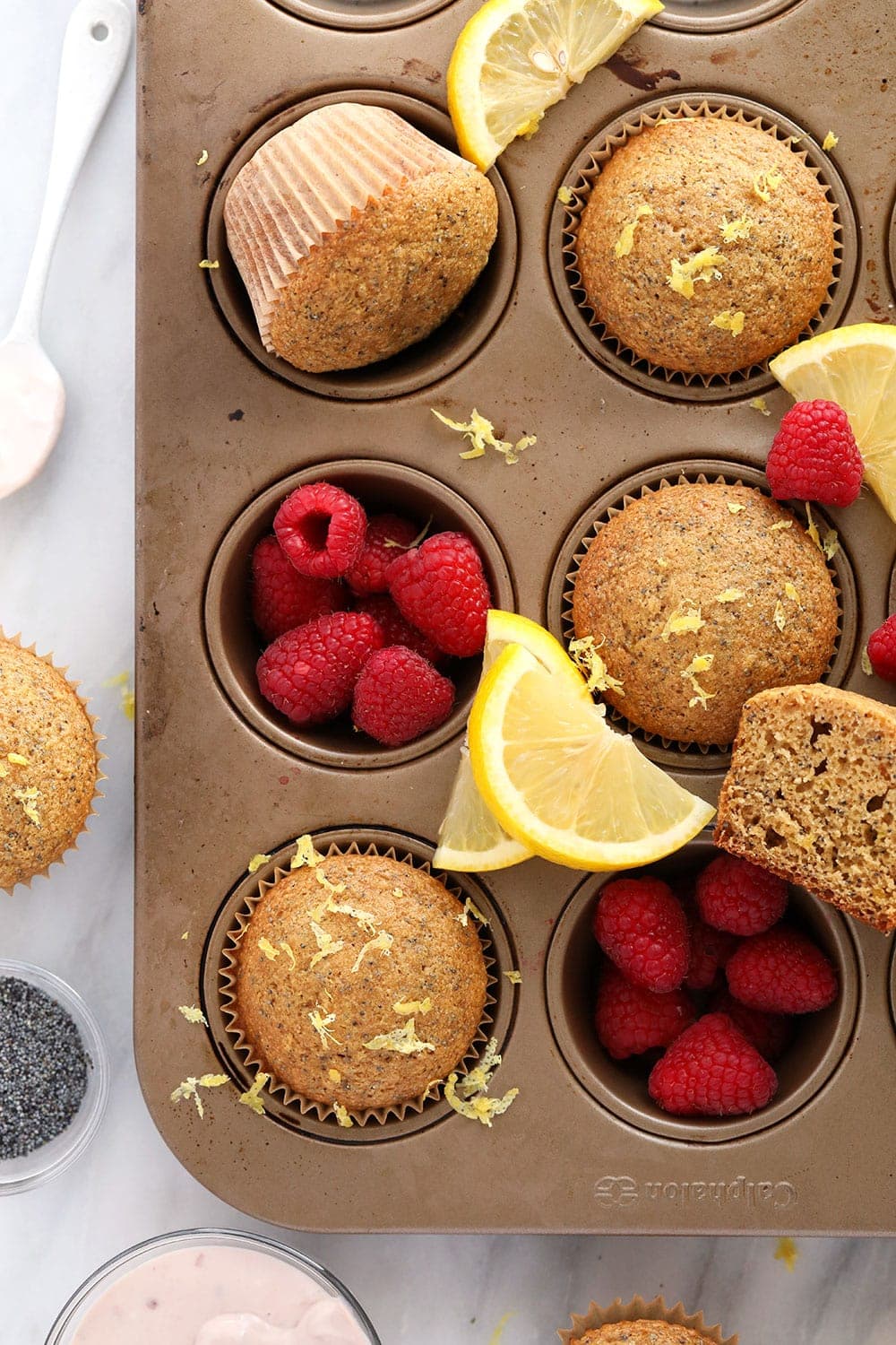 healthy lemon poppy seed muffins in a muffin tin