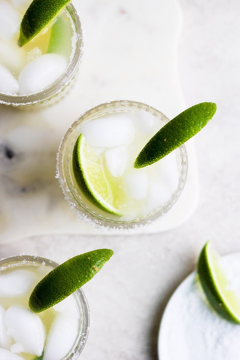 margaritas in glass with lime