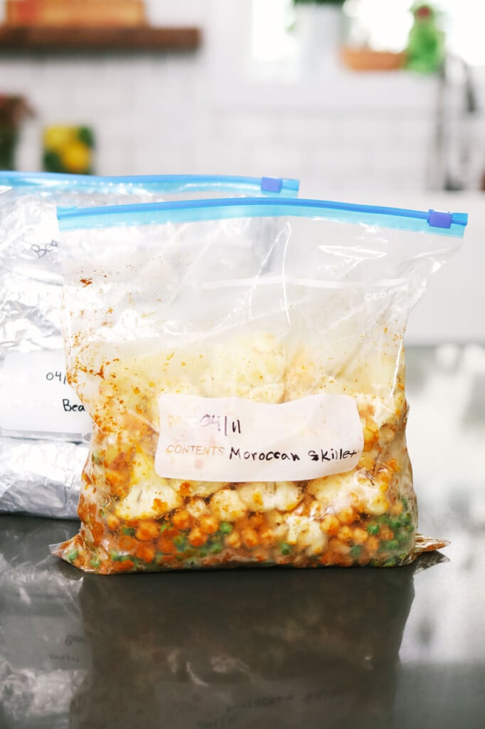 Two freezer bags of vegetarian meals resting on a kitchen counter.