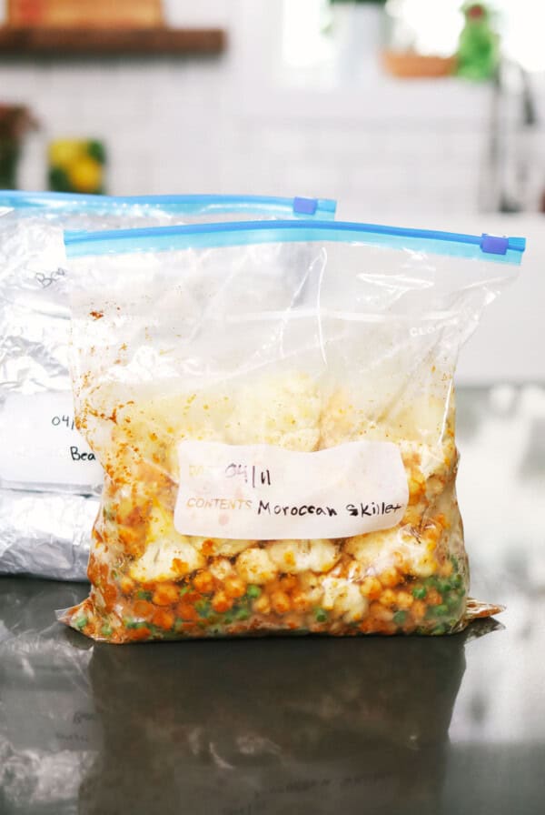 Two freezer bags of vegetarian meals resting on a counter.