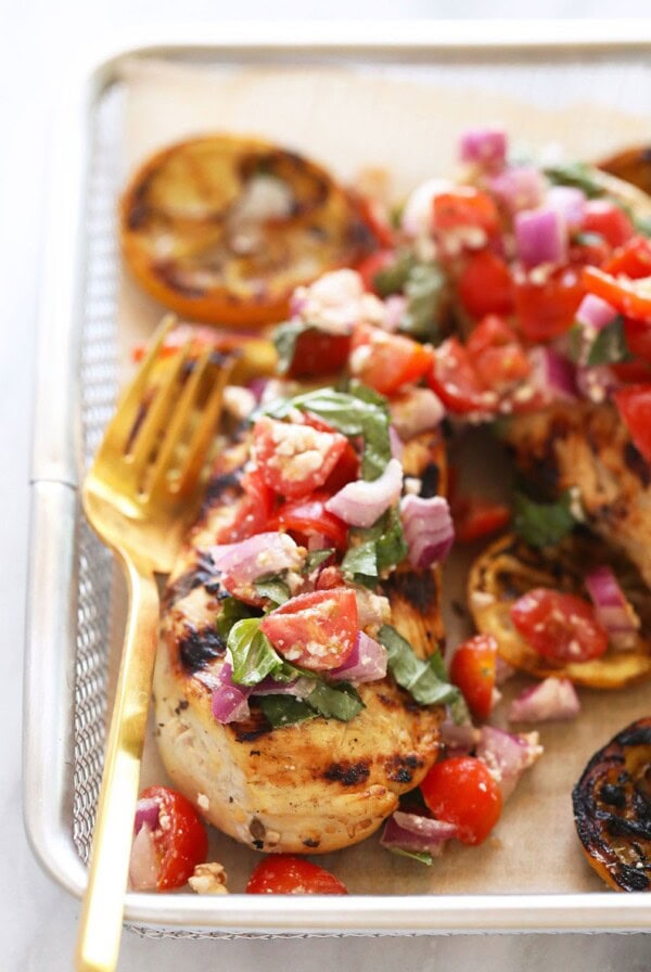 Grilled Greek lemon chicken in a basket served with Greek salad.