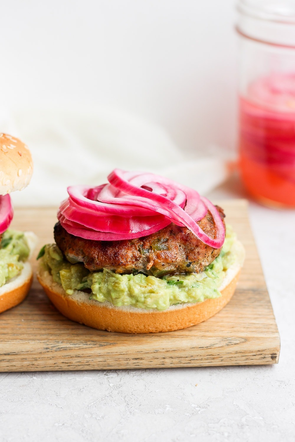 turkey burgers topped with pickled onions.