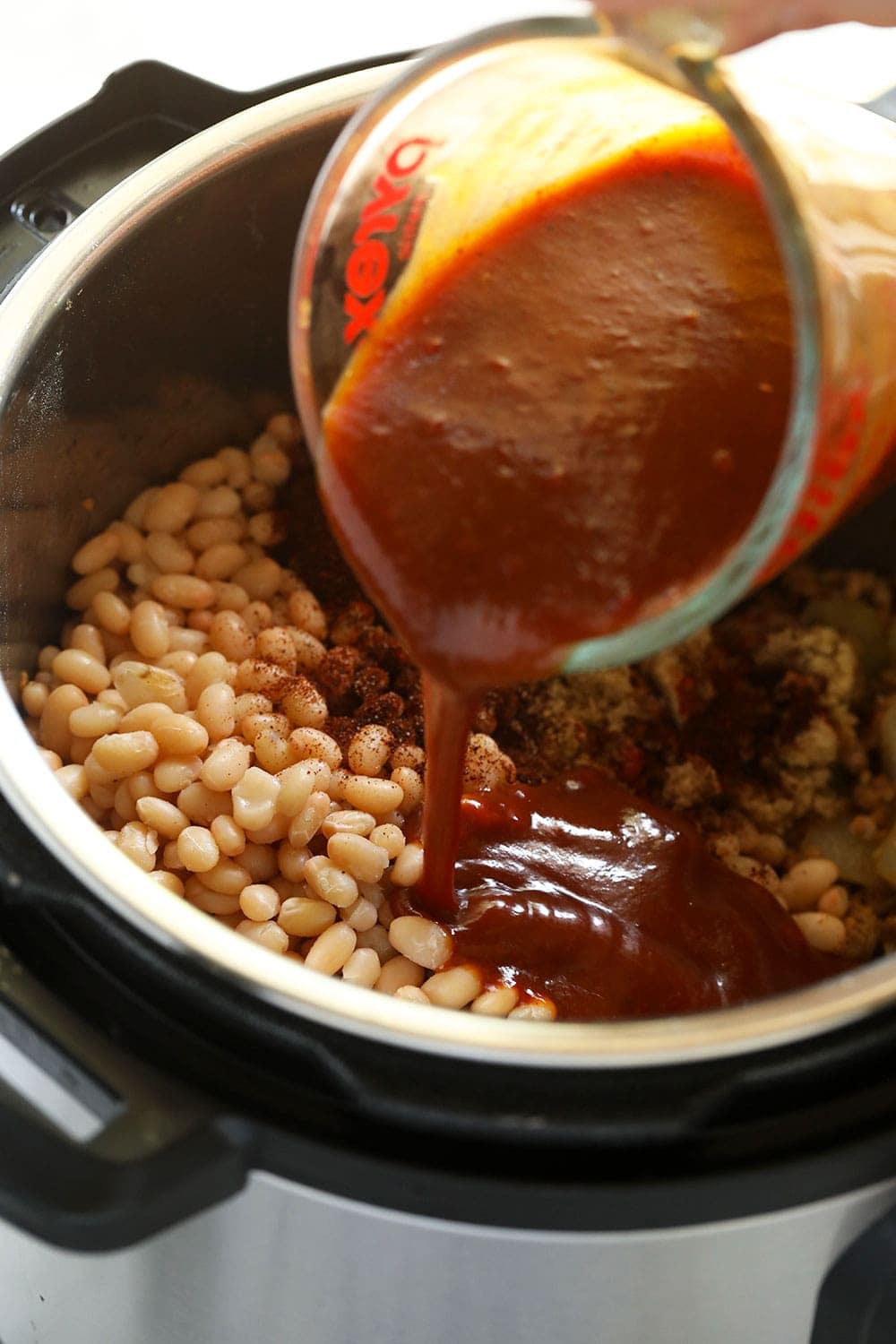 Pouring BBQ sauce into the Instant Pot! 