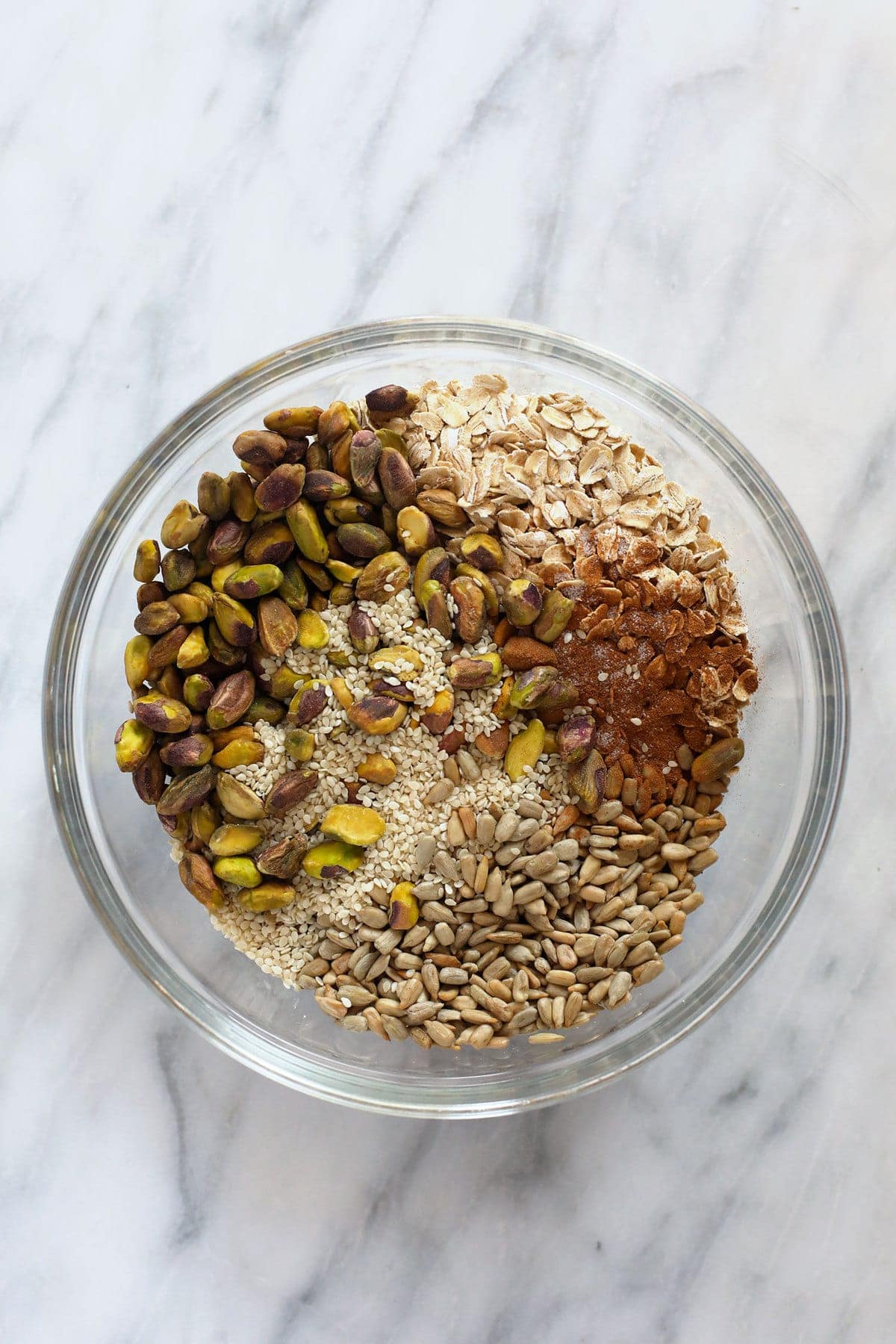 All of the ingredients for pistachio cherry granola in a bowl. 