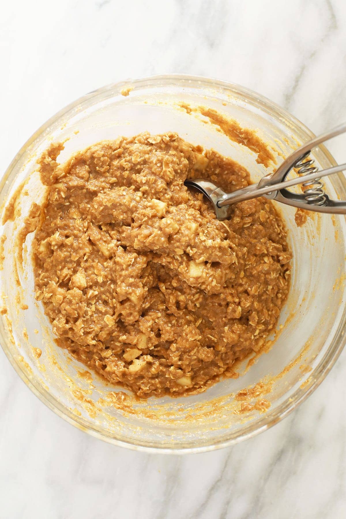 Apple oatmeal cookies batter in bowl. 