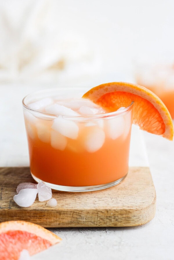 paloma cocktail in a glass with ice and a grapefruit slice garnish