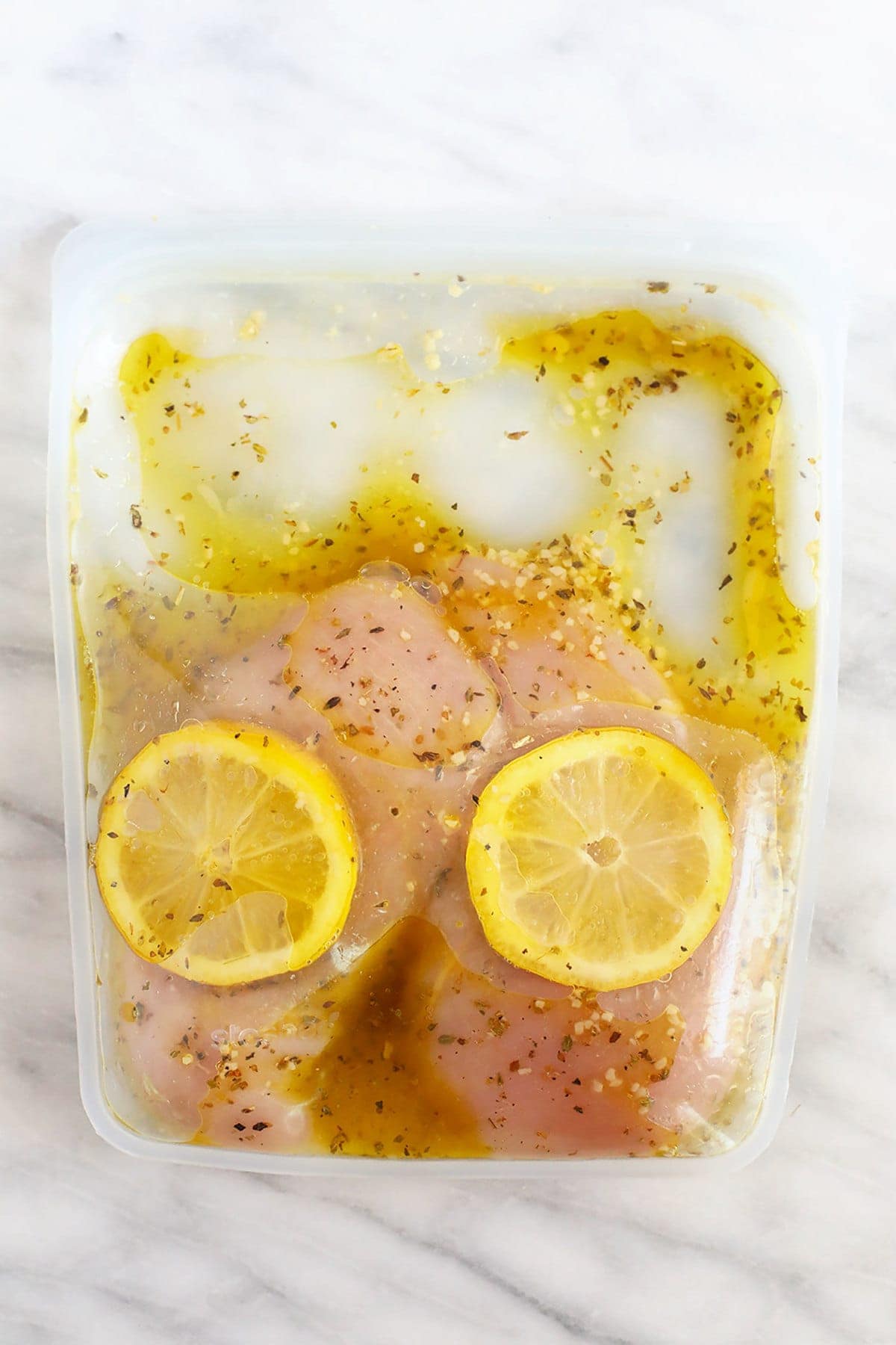 chicken marinating in Stasher bag with lemon