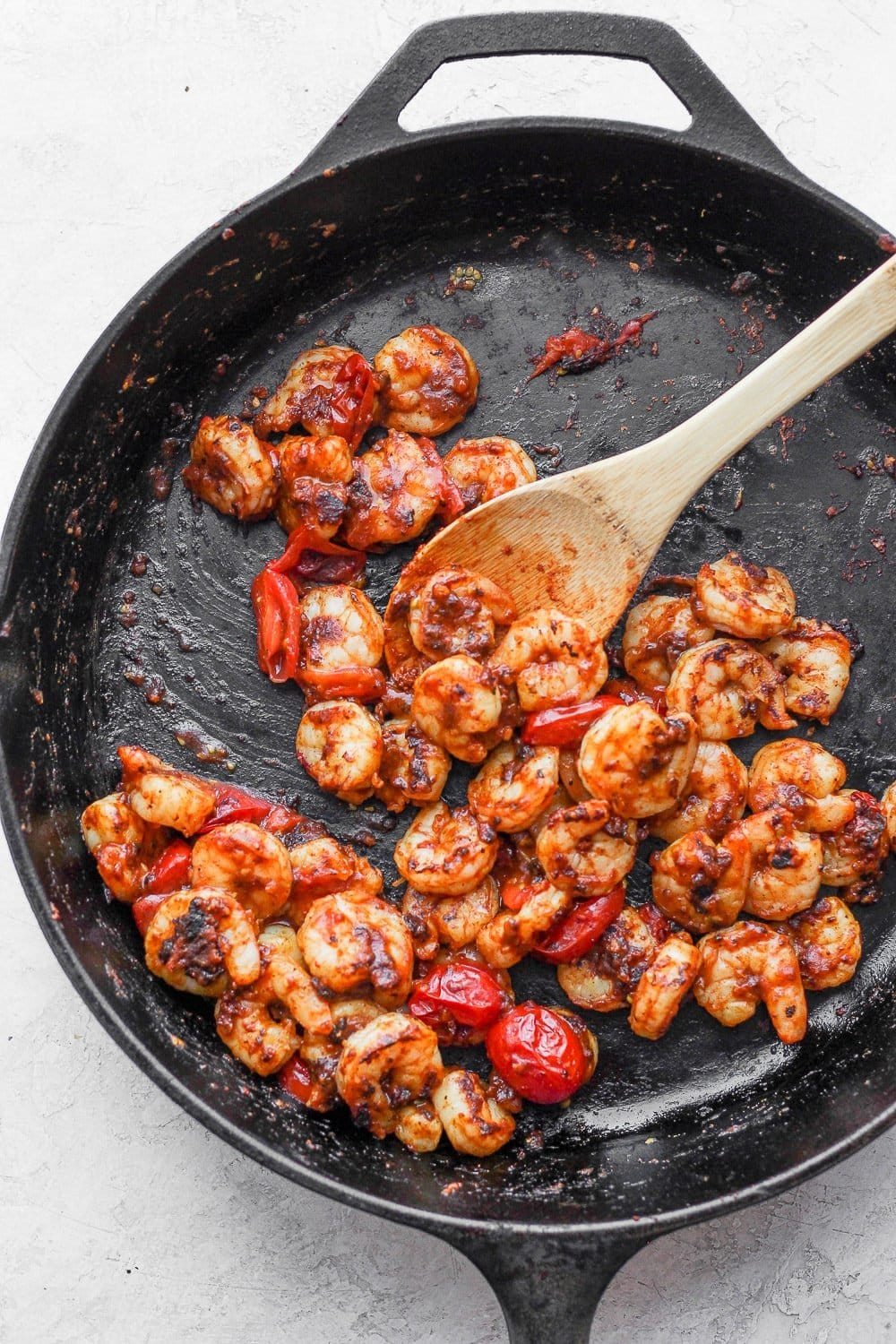 shrimp being cooked in a cast iron skillet