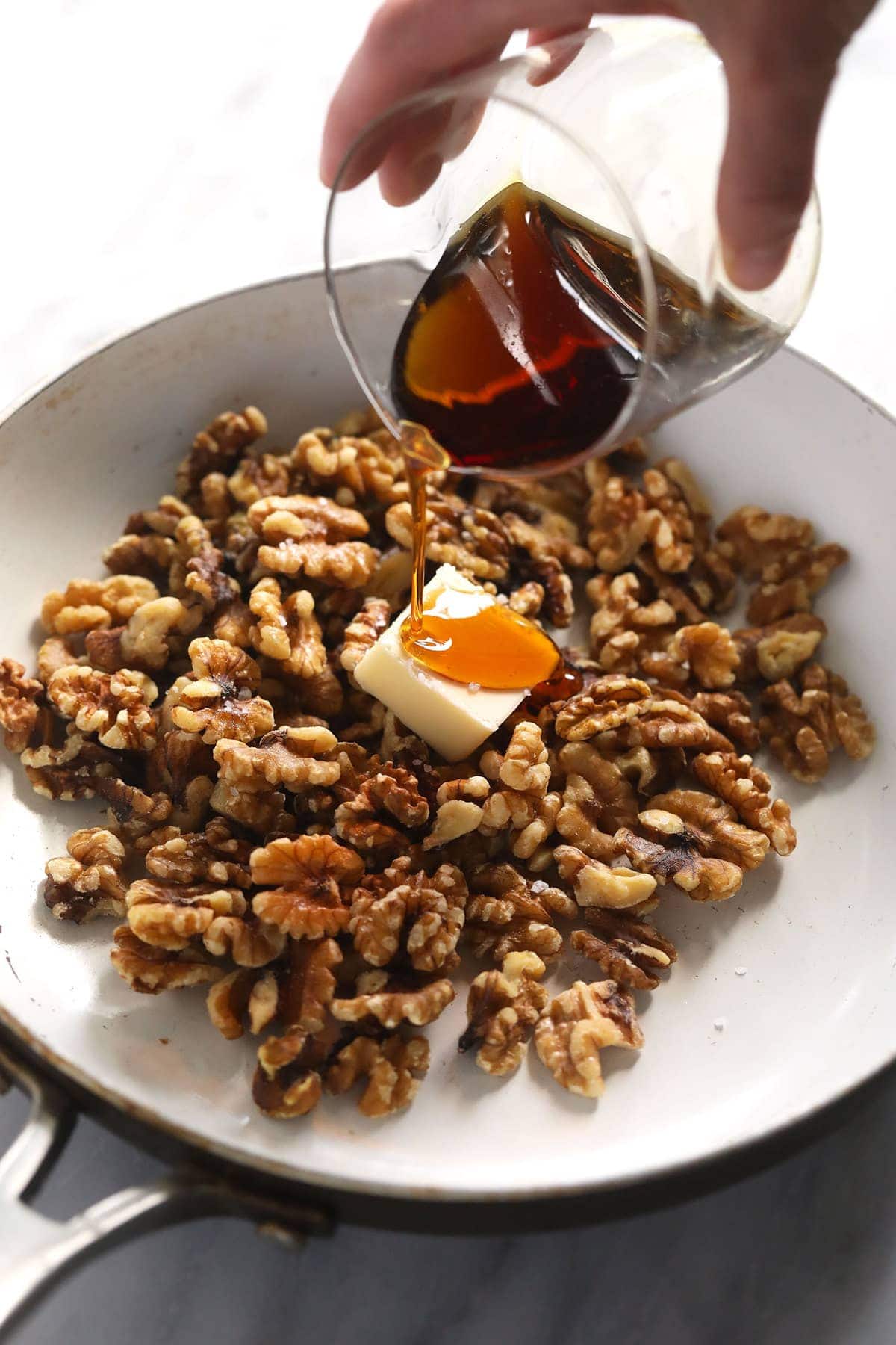 Pouring maple syrup in a pan. 