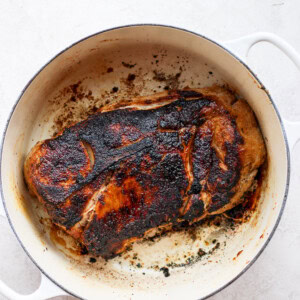 A baked pork roast on a white surface.