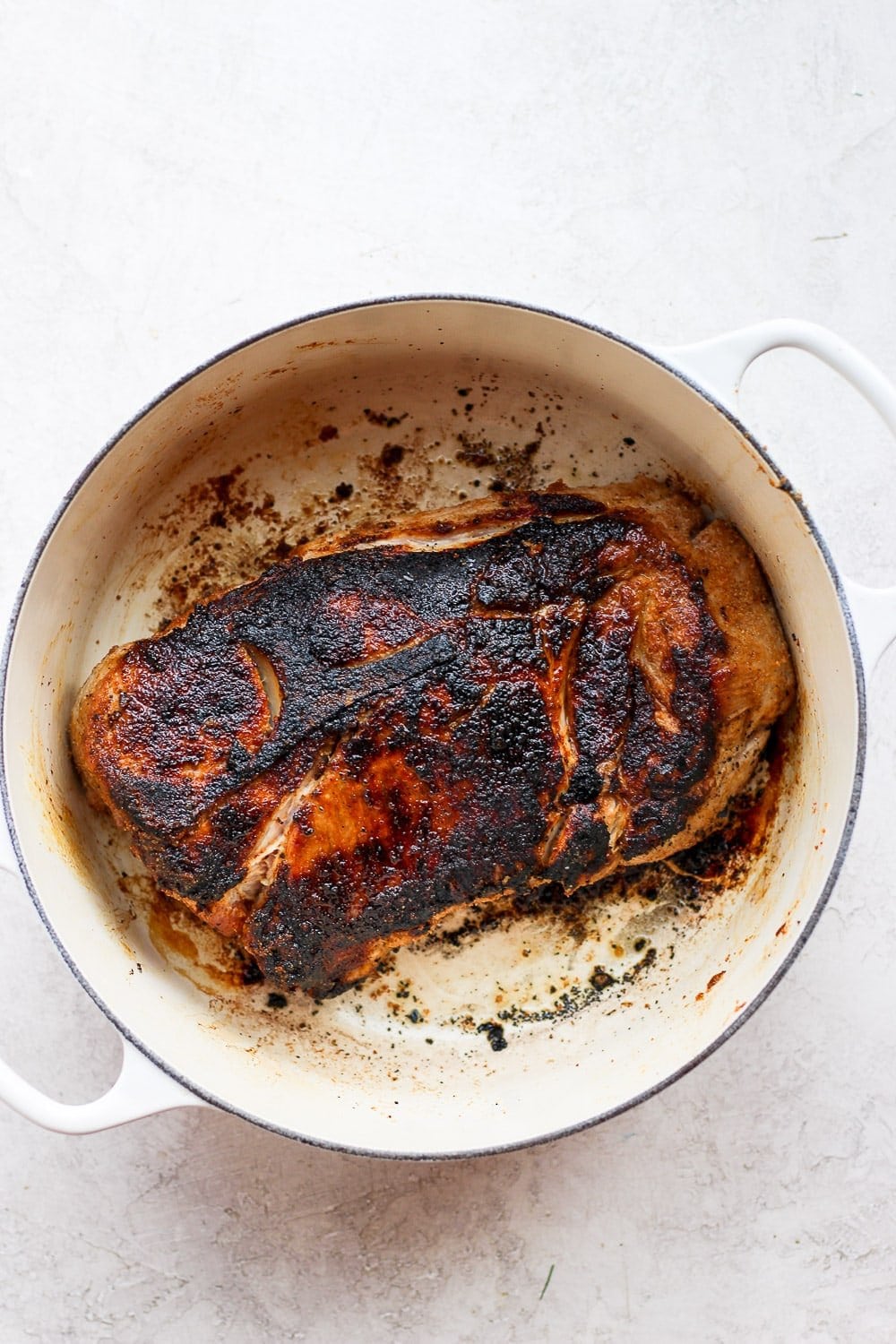 seared pork shoulder in a stock pot