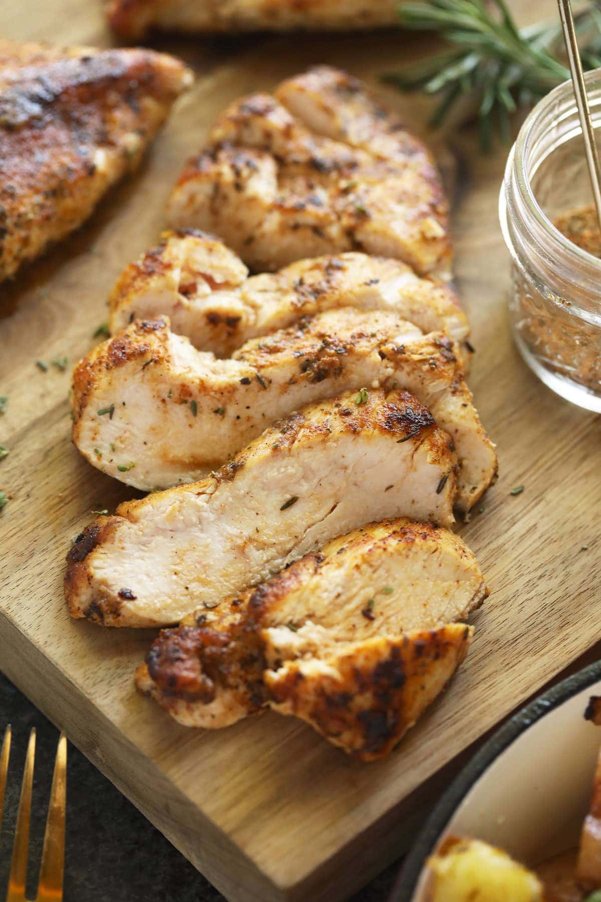 sliced chicken breast on cutting board