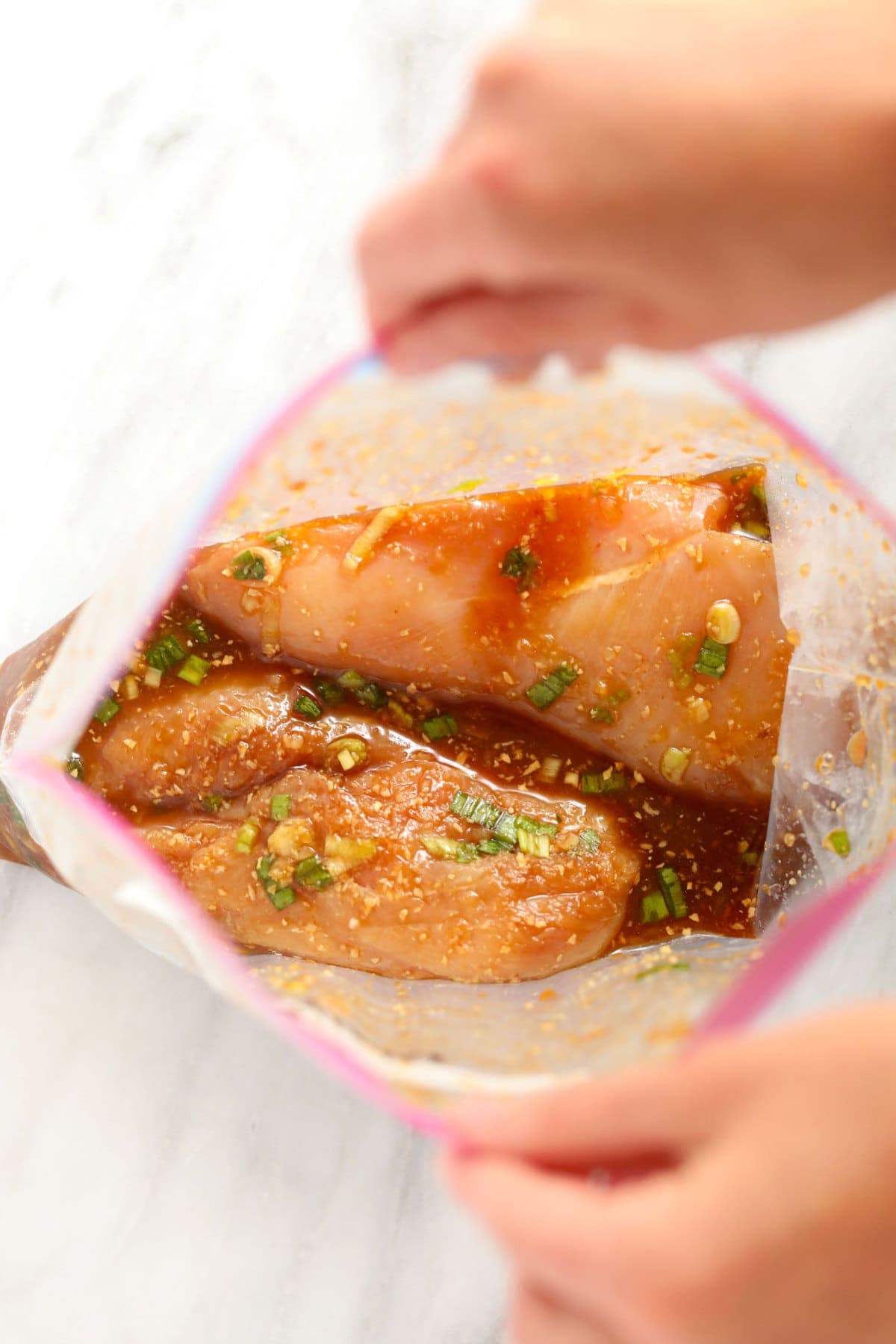 chicken marinating in plastic bag