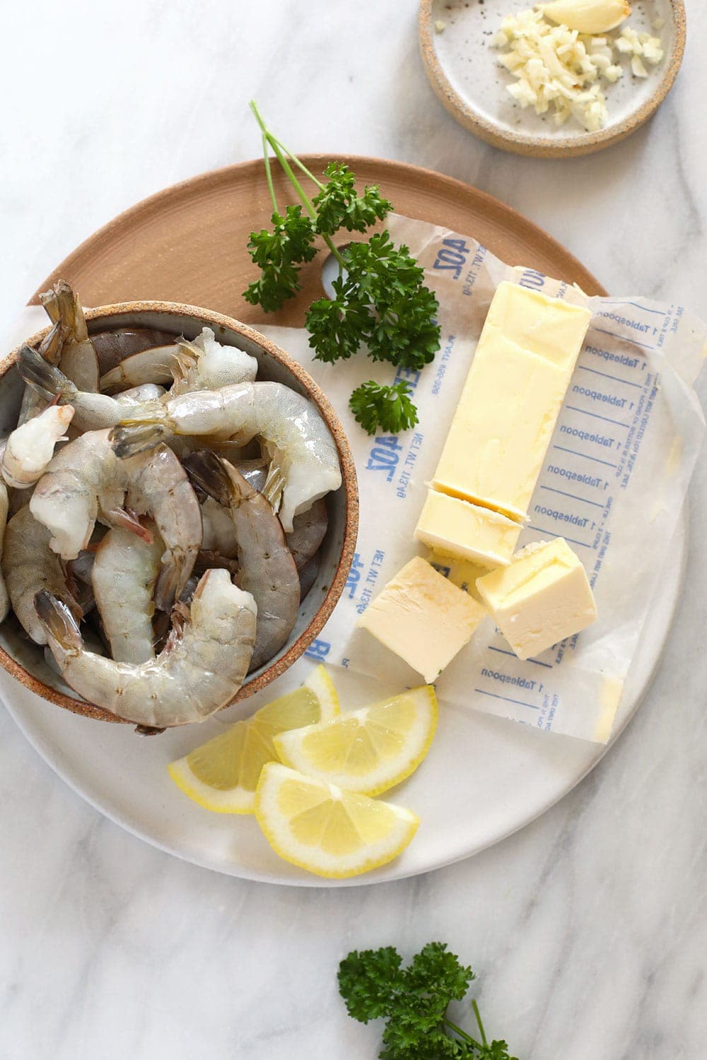 raw shrimp with butter, ready to be sautéed in a skillet 