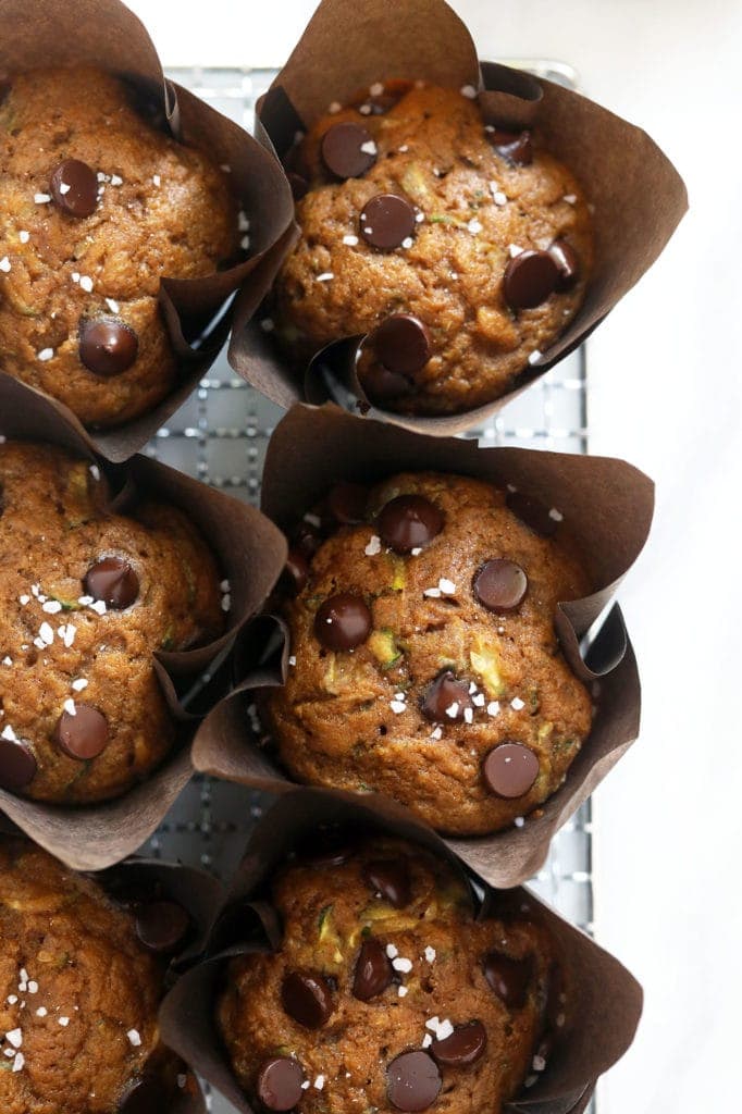 zucchini muffins on wire rack.