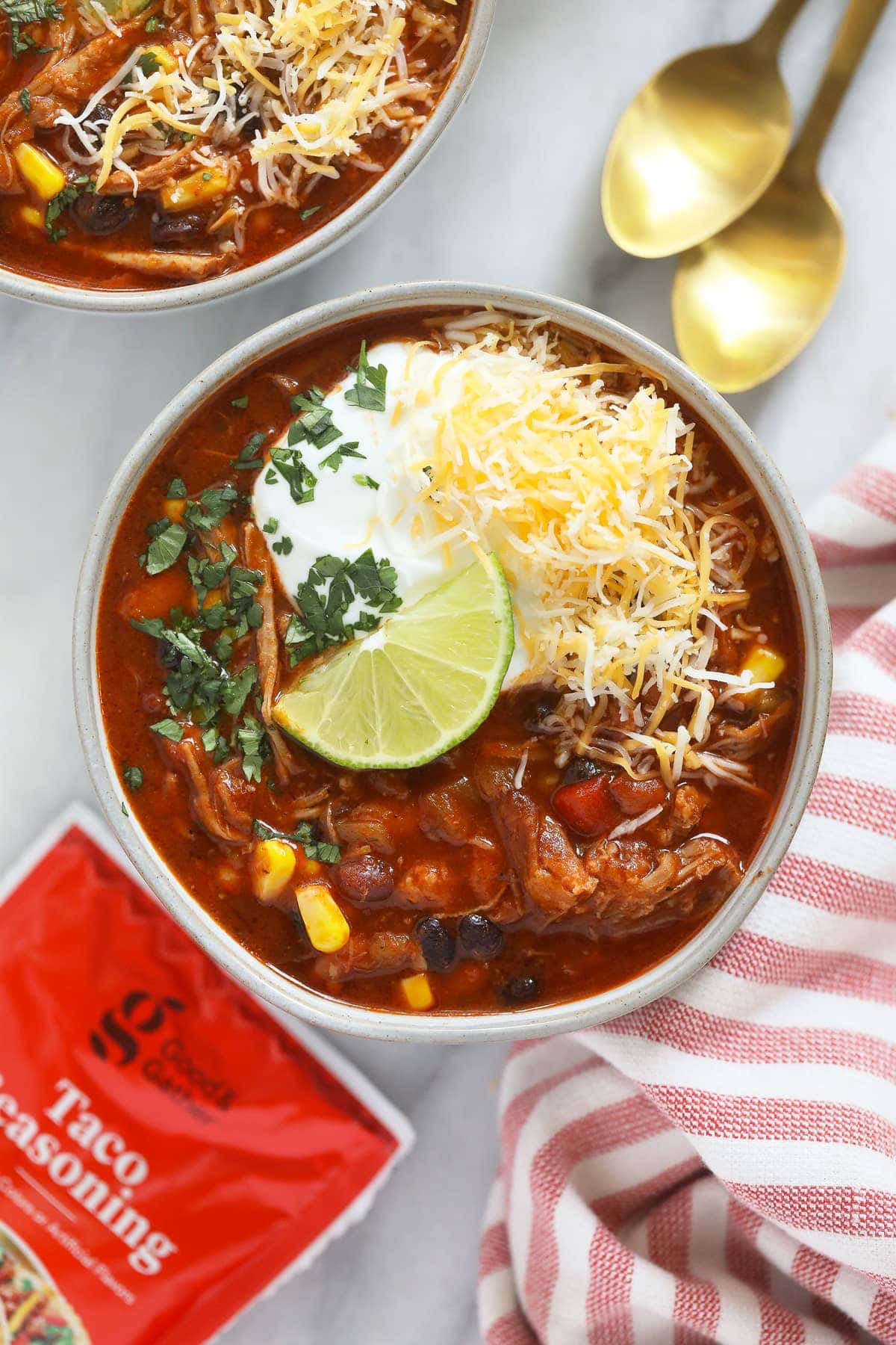 pork chili in bowl with lime wedge.